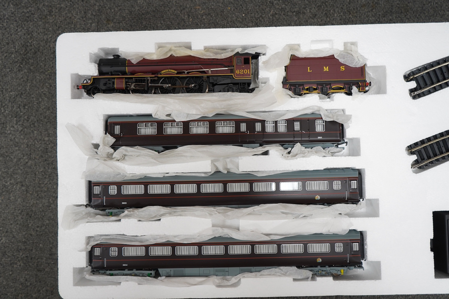 Three Hornby 00 gauge railway boxed train sets; The Royal Train (R1057), the Cornish Riviera Express (R826) and The Caledonian (R775), each comprising of a tender locomotive, three coaches, track sections, controllers, e